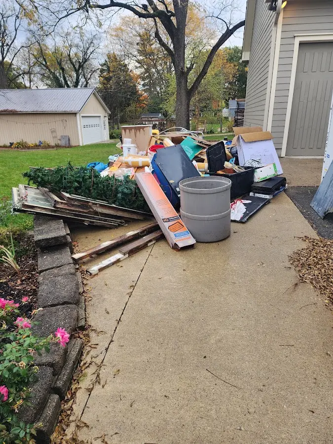 Dumpster being loaded with debris for Residential Dumpster Rental in Winooski